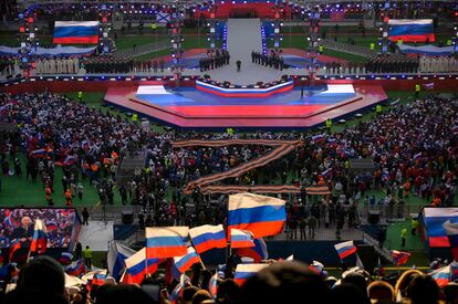 A crowd listens to Russian President Vladimir Putin's speech during a Defender of the Fatherland Day event at the Luzhniki stadium in Moscow on February 22, 2023.