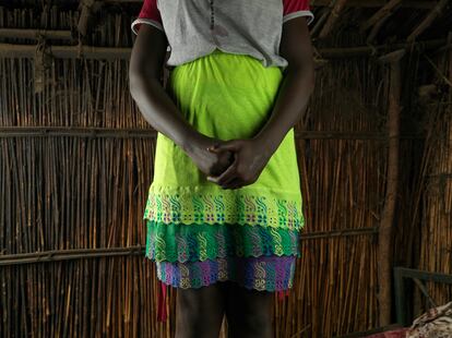 “I put on many layers of clothes so that I can go to school during my period,” says 19-year-old Nyawura Liey, standing outside her home in the Bentiu IDP camp.