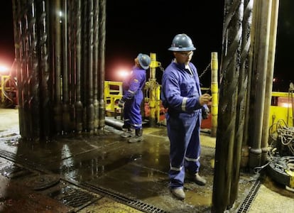 An operator works on an oil drill in Venezuela.