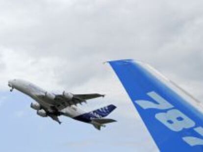 The vertical stabilizer of a Boeing 787 Dreamliner as an Airbus A380 takes off during the 49th Paris Air Show at the Le Bourget airport near Paris.