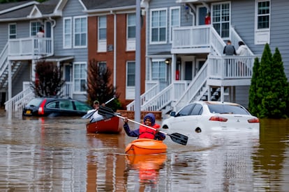 Residents paddle through the waters of their neighborhood after Tropical Storm Helene passes through Atlanta, Georgia, on September 27, 2024.