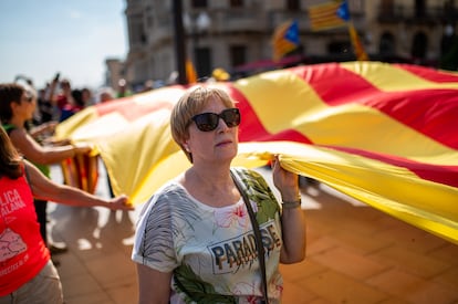 Una mujer sostiene una gran bandera independentista durante la protesta en Tarragona.