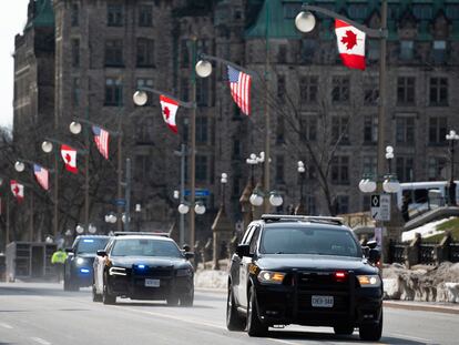 Ontario Provincial Police vehicles speed along Wellington Street in preparation of U.S. President Joe Biden's visit in Ottawa, Ontario, on Wednesday, March 22, 2023.