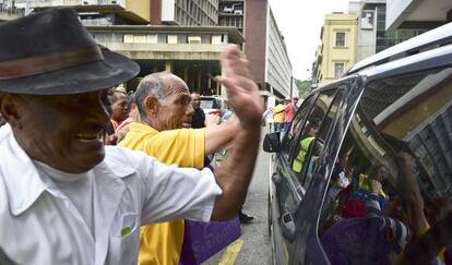 Pro-government supporters hit the car of Henry Ramos Allup, the newly elected president of the National Assembly.