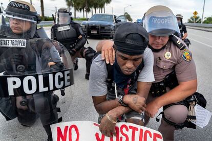 Miembros de la policía con un manifestante, durante una protesta el 2 de junio en Boca Ratón (Florida).
