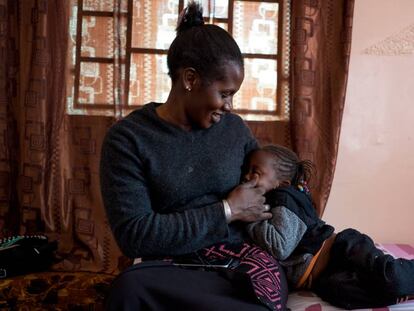 Mbayam Diop, de 30 años y esposa de emigrante, acaricia a su hija Mamita en el salón de su vivienda en Gandiol, en el distrito senegalés de Saint Louis.