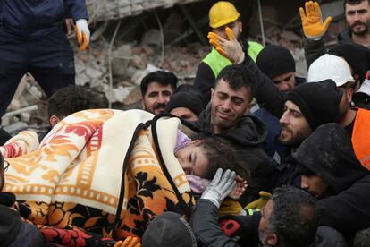 Rescuers carry out a girl from a collapsed building following an earthquake in Diyarbakir, Turkey.