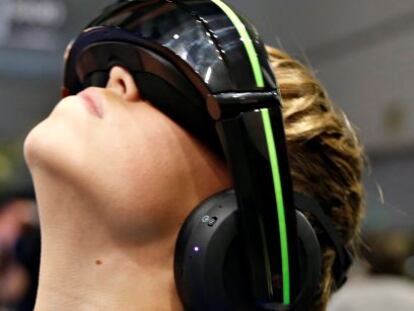 Un joven probando unos cascos con gafas de realidad virtual.