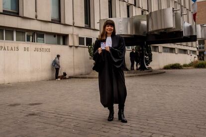 Carine Delaby-Faure, 50, a lawyer who works in Lille in northern France, married with two children, poses with her voting card on February 16, 2017 in front of the Lille Courthouse.
What should be the priorities of the next French president?
"To be honest, my approach is more one of rejection than expectation. I don't have any particular expectation but I do fear what appears to be in the offing -- the election of a candidate who really scares me, Marine Le Pen, and we have to do everything possible to block that... Having said that, what I would like above all else is that we can be proud of the next president. Some French politicians make me ashamed and I dream of seeing the sort of transparency and exemplary behaviour that you get (from politicians) in Nordic countries. The other quality I'd require is that the president is fundamentally European and protects the most needy." / AFP PHOTO / PHILIPPE HUGUEN / RESTRICTED TO EDITORIAL USE - RESTRICTED TO FRENCH ELECTIONS ILLUSTRATION PURPOSE