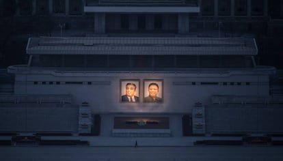 Un ciudadano pasea debajo de los dos grandes retratos de Kim Il-Sung (izq.) y Kim Jong-Il (der.) en Pyongyang.