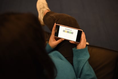 A user plays the English version of Wordle on his cell phone.