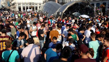 Jóvenes jugadores de Pokemon quedan en la Puerta del Sol de Madrid.