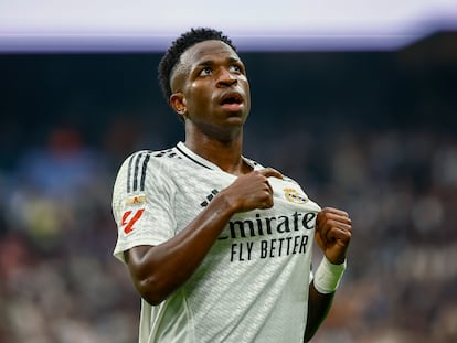 Vinicius celebra un gol ante Osasuna señalando el escudo del Real Madrid.