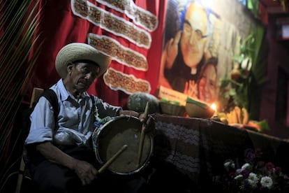 A man plays the drum at a family altar during the celebration of "Los Canchules" in Nahuizalcoams November 1, 2015. People remember their deceased relatives and friends during All Saints Day by preparing altars and sharing food with all visitors, prior to the Day Of the Dead. REUTERS/Jose Cabezas