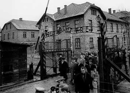 Supervivientes y participantes en el juicio de Auschwitz en Francfort ante las puertas del campo de concentración el 14 de diciembre de 1964.