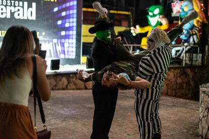 Two nightclub workers in fancy dress provide a photo op for tourists at Coco Bongo.