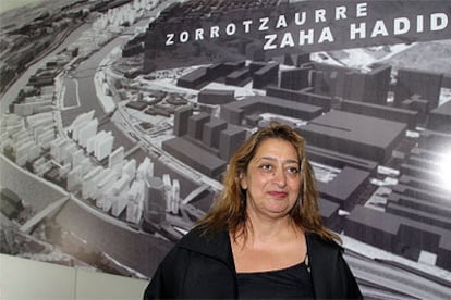 Zaha Hadid posó ayer en Bilbao ante una imagen infográfica del plan que ha diseñado para el desarrollo de Zorrozaurre.