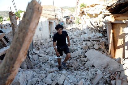 A man walks among collapsed buildings at the village of Vrissa on the Greek island of Lesbos, Greece, after a strong earthquake shook the eastern Aegean, June 12, 2017. REUTERS/Giorgos Moutafis