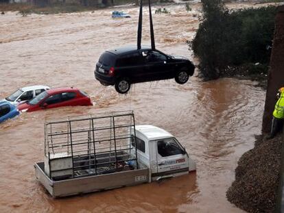 Varios coches anegados en el río Palancia a por las intensas lluvias registradas en Valencia (España).