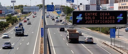 “Only justified travel allowed between regions,” reads this sign on the S30 highway to Seville.