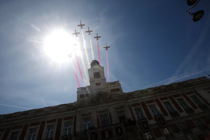 La patrulla Águila sobrevuela la Real Casa de Correos, sede del Gobierno de la Comunidad de Madrid, en la Puerta del Sol.