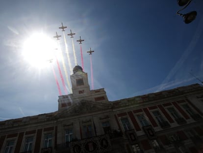 La patrulla Águila sobrevuela la Real Casa de Correos, sede del Gobierno de la Comunidad de Madrid, en la Puerta del Sol