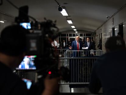 Donald Trump addresses reporters in the hallway of the Manhattan courthouse on Friday.