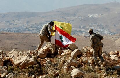 Hezbollah fighters put Lebanese and Hezbollah flags at Juroud Arsal, Syria-Lebanon border, July 25, 2017.