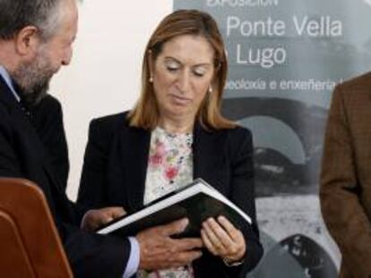 La ministra de Fomento, Ana Pastor, que asistió a la inauguración de las obras de rehabilitación de A Ponte Vella, el puente romano sobre el río Miño, en Lugo, recibe un regalo del alcalde de la ciudad, José López Orozco.