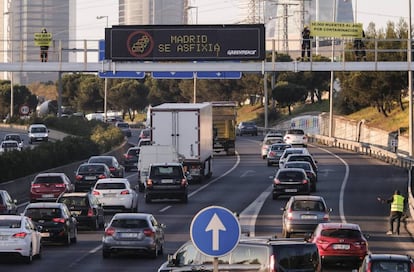 Activistas de Greenpeace durante una acción en la M-30 para denunciar la contaminación en Madrid.