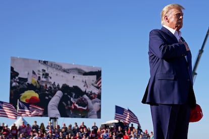 President Donald Trump stands while a song, "Justice for All," is played during a campaign rally at Waco Regional Airport