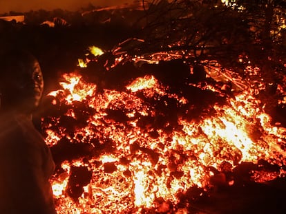 Una persona se para frente a la lava de la erupción del volcán Nyiragongo, en Buhene, en las afueras de Goma.