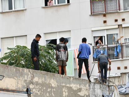 Un policía nacional trabaja para que un grupo de menores migrantes abandone el tejado de una nave industrial donde habían sido alojados, el pasado 27 de agosto en Ceuta.