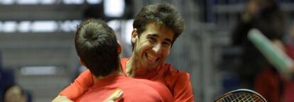 Marc L&oacute;pez (right) embraces Marcel Granollers after the pair secured the winning point.