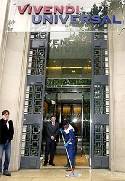 Un empleado limpia la entrada de las oficinas centrales de Vivendi Universal en París.