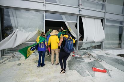 Supporters of Brazil's former president Jair Bolsonaro, storm the Planalto Palace in Brasília, Brazil, Sunday, Jan. 8, 2023.