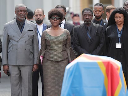 The three surviving children of Patrice Lumumba behind the coffin containing their father's tooth, in Brussels, last Monday.