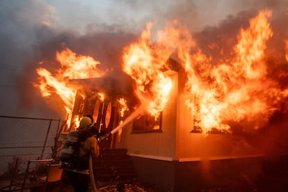 A firefighter battles the Palisades Fire on the west side of Los Angeles on January 7, 2025.