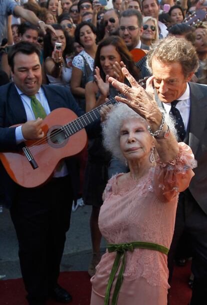 The Duchess of Alba, Cayetana Fitz-James Stuart, and Alfonso Díez Carabantes, dance a traditional sevillana at the gates of Dueñas Palace.