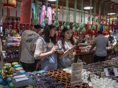 Ciudadanos chinos visitan una tienda en el distrito comercial de Wangfujing, en Pek&iacute;n.