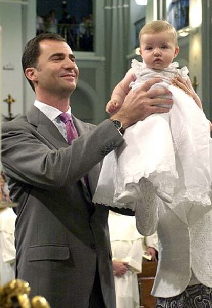 La infanta Leonor, en brazos de sus padres durante el ofrecimiento a la Virgen de Atocha.