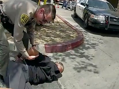 In this image taken from police body camera provided by Los Angeles Sheriff's office on June 24, 2023, a  Sheriff's deputy arrests a couple in a grocery store parking lot in Lancaster, California.