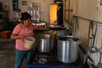 A woman cooks in the Nueva Esperanza communal kitchen in Lima's San Juan de Lurigancho district.