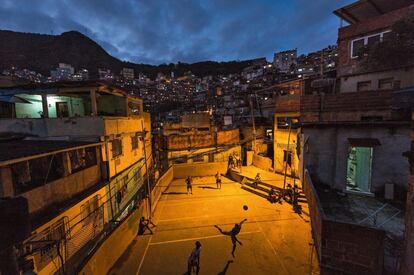 Un grupo de amigos juega una variante del deporte rey, el voley-fútbol, en un patio interior de la favela Rocinha, la más poblada de Río de Janeiro, donde se hacinan más de 70.000 vecinos. La policía intenta pacificar los barrios más deprimidos de la ciudad de cara a la copa del mundo con redadas y presencia continua de efectivos en las calles.