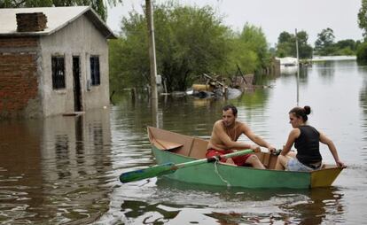 Una pareja de uruguayos rema un bote en las calles inundadas de Durazno en 2010.