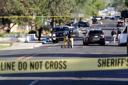 Investigators work along a residential street following a deadly shooting on May 15, 2023, in Farmington, New Mexico.