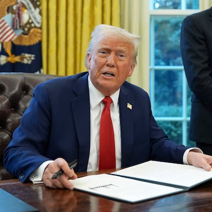 President Donald Trump speaks as Commerce Secretary Howard Lutnick listens in the Oval Office of the White House, Monday, Feb. 3, 2025, in Washington, as Trump prepares to sign an executive order. (AP Photo/Evan Vucci)