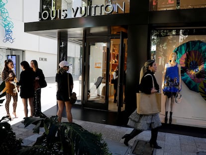 Gente paseando frente a una tienda de Louis Vuitton en Miami.