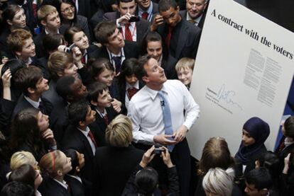 David Cameron, junto a un cartel con su firma donde se lee: "Un contrato con los votantes", ayer en Derby.