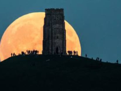 Imagen de una gran luna llena en Glastonbury Tor, Inglaterra.